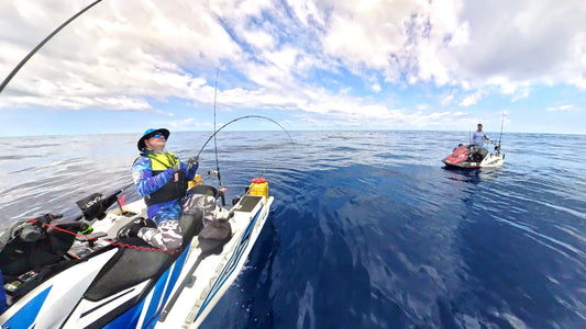 Two man jetski fishing,one has a fish on the line