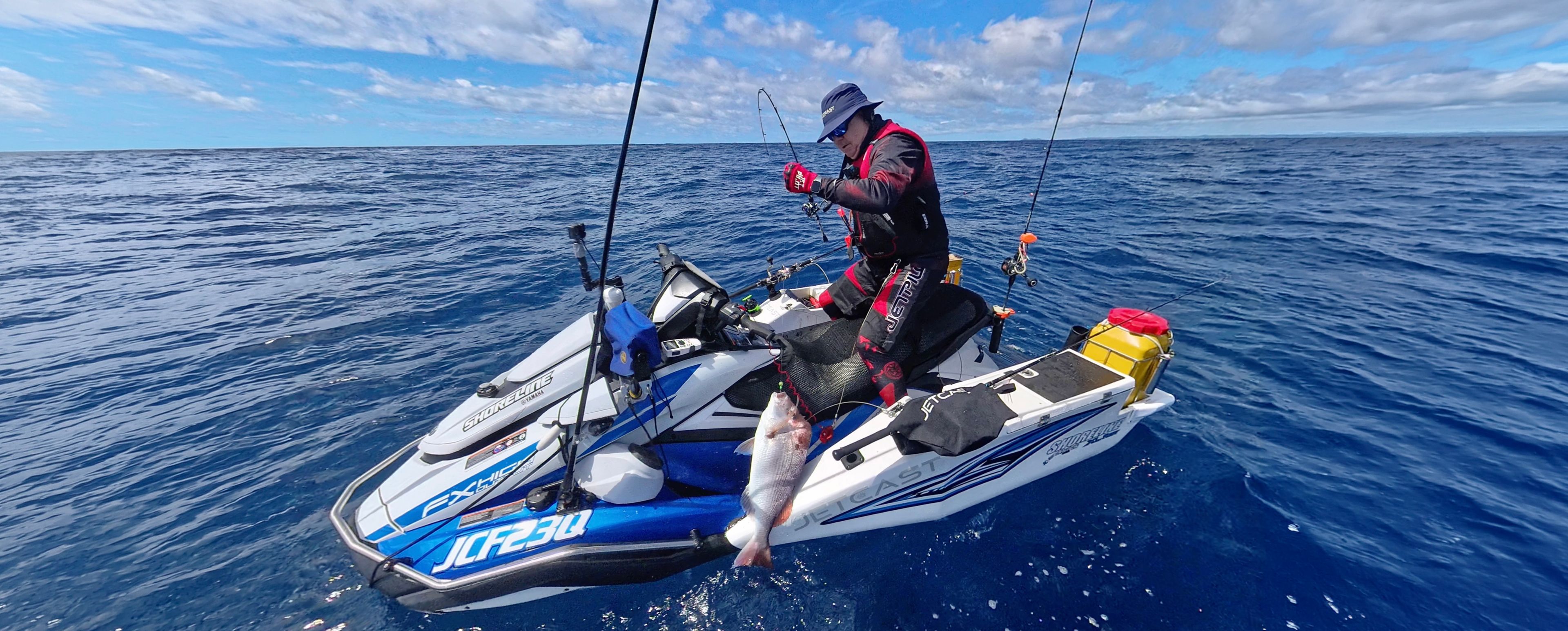 Person on a jet ski with fishing equipment catching fish on the ocean